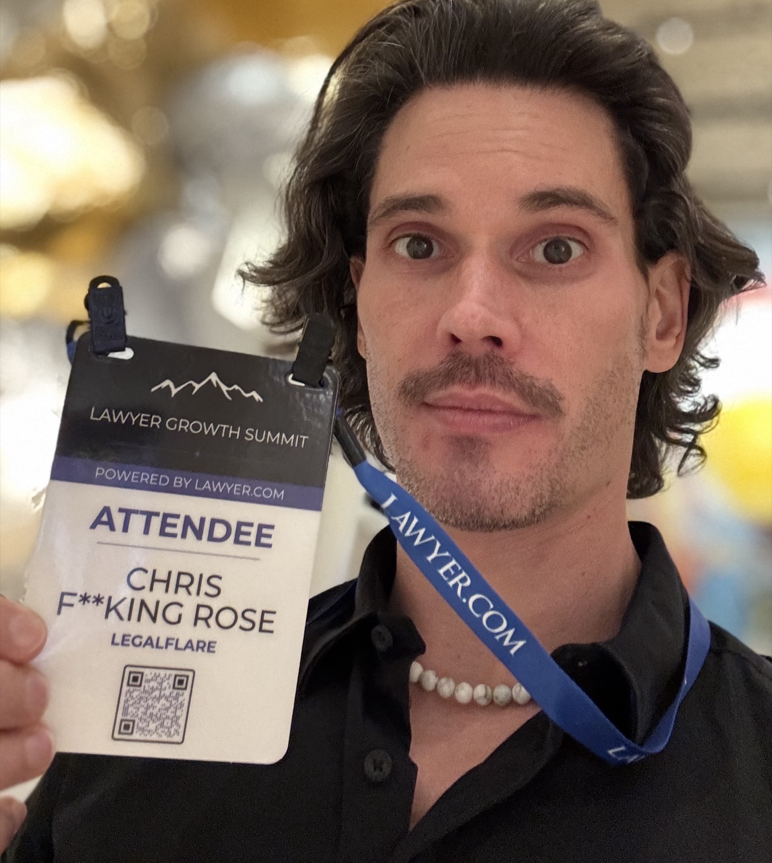 Chris holding his Lawyer Growth Summit badge